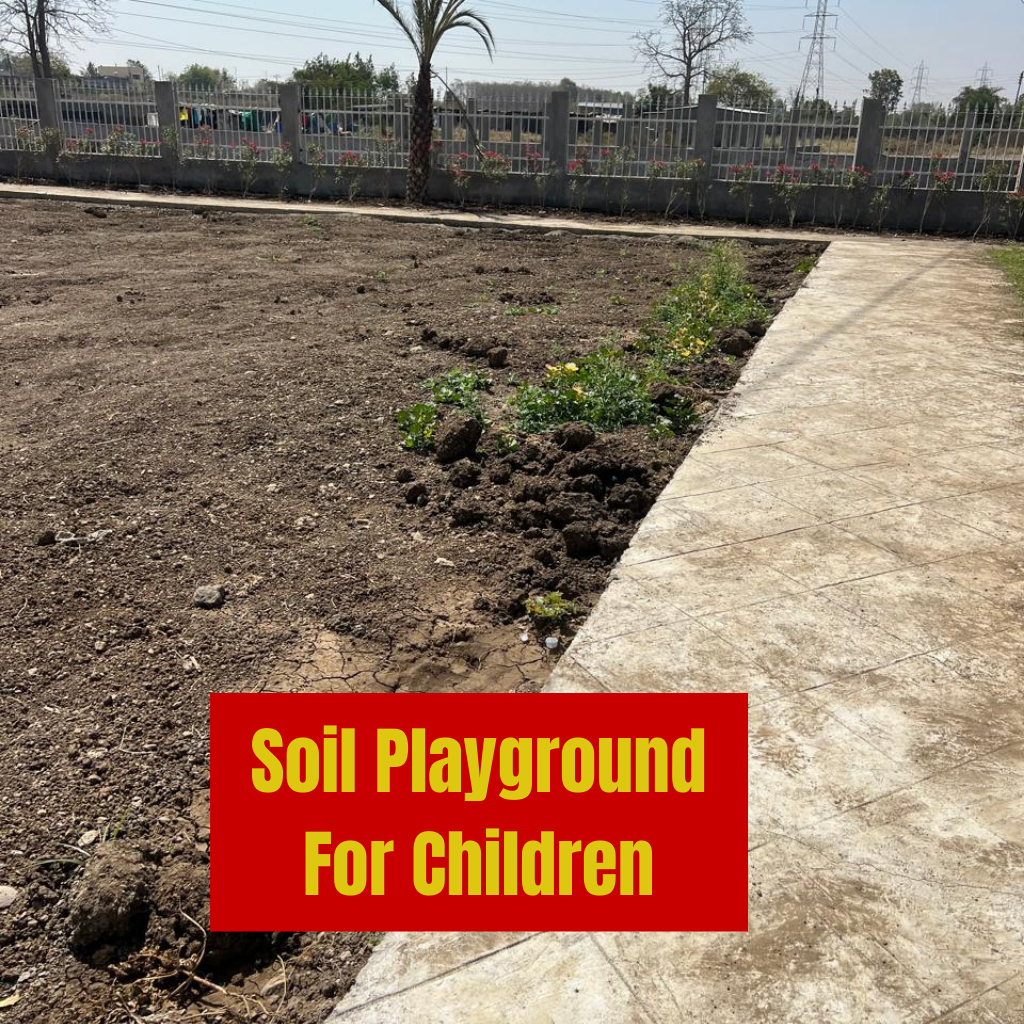 Child-friendly soil playground with play equipment at Katol Road Nagpur residential layout featuring safe natural play surfaces